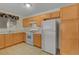 Functional kitchen features light wood cabinets, white appliances, and tile floors at 8725 W Flamingo Rd # 240, Las Vegas, NV 89147