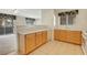Open kitchen design with wood cabinets, plenty of counter space, and tile flooring at 8725 W Flamingo Rd # 240, Las Vegas, NV 89147