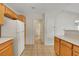 Functional kitchen featuring tile floors, cabinetry, white appliances and access to a half bathroom at 8725 W Flamingo Rd # 240, Las Vegas, NV 89147