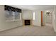 Cozy living room features a fireplace, a large window, and soft, neutral carpet at 8725 W Flamingo Rd # 240, Las Vegas, NV 89147