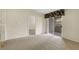 Neutral living room featuring carpeted floors and access to an outdoor patio at 8725 W Flamingo Rd # 240, Las Vegas, NV 89147