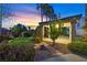 Landscaped backyard featuring a covered patio, manicured lawn, and stone pathway at 9008 Sawhill Pond St, Las Vegas, NV 89131