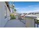 Balcony with views of palm trees and neighboring homes with solar panels under a blue sky at 9008 Sawhill Pond St, Las Vegas, NV 89131