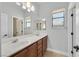 Well-lit bathroom boasting dual sinks, a large mirror, and plenty of counter space for convenience at 9008 Sawhill Pond St, Las Vegas, NV 89131