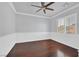 Cozy bedroom featuring hardwood floors, crown molding, and a bright, sunlit window at 9008 Sawhill Pond St, Las Vegas, NV 89131