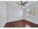 Bright bedroom with hardwood floors, plantation shutters, and a modern ceiling fan at 9008 Sawhill Pond St, Las Vegas, NV 89131