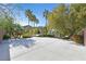 Long driveway leading to a landscaped backyard with gazebo and palm trees at 9008 Sawhill Pond St, Las Vegas, NV 89131