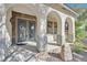 Covered front entry featuring decorative glass doors and stone accents at 9008 Sawhill Pond St, Las Vegas, NV 89131