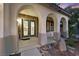 Elegant front porch featuring stone accents, graceful archways, and decorative front doors at 9008 Sawhill Pond St, Las Vegas, NV 89131