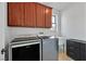 Functional laundry room with updated cabinets and modern washer and dryer at 9008 Sawhill Pond St, Las Vegas, NV 89131
