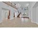 Bright living room featuring hardwood and tile floors, a staircase, and large windows at 9008 Sawhill Pond St, Las Vegas, NV 89131