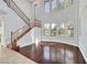 Elegant living room with hardwood floors, large windows, and a view of the staircase at 9008 Sawhill Pond St, Las Vegas, NV 89131