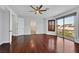 Open living room with hardwood floors, ceiling fan, and sliding glass doors opening to a balcony at 9008 Sawhill Pond St, Las Vegas, NV 89131