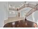 Expansive living room showcasing hardwood and tile floors, a staircase, and a chandelier at 9008 Sawhill Pond St, Las Vegas, NV 89131