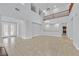 Open living room with tile flooring, a chandelier, and a view of the second-floor balcony at 9008 Sawhill Pond St, Las Vegas, NV 89131