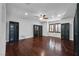 Spacious living room featuring hardwood floors, modern built-in cabinets, ceiling fan, and ample natural light at 9008 Sawhill Pond St, Las Vegas, NV 89131