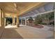 Inviting covered patio with ceiling fans and a desert landscaped backyard area at 9008 Sawhill Pond St, Las Vegas, NV 89131