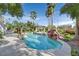 Resort-style pool with rock waterfall and gazebo amidst lush landscaping at 9008 Sawhill Pond St, Las Vegas, NV 89131