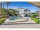 Spectacular pool area with rock features and tropical landscaping in backyard at 9008 Sawhill Pond St, Las Vegas, NV 89131