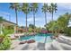 Beautiful pool area with tropical landscaping and rock waterfall feature at 9008 Sawhill Pond St, Las Vegas, NV 89131