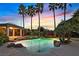 Luxurious swimming pool and spa surrounded by lush landscaping and a relaxing covered patio area at 9008 Sawhill Pond St, Las Vegas, NV 89131