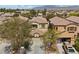 An aerial view of a neighborhood showcasing a well-maintained home and surrounding landscaping at 9060 Watermelon Seed Ave, Las Vegas, NV 89143