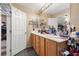 Bathroom with double sinks, vanity and large mirror at 9060 Watermelon Seed Ave, Las Vegas, NV 89143