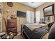 Cozy bedroom with large windows, natural light, carpeted floors, and dark wood furniture at 9060 Watermelon Seed Ave, Las Vegas, NV 89143