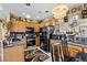 Well-lit kitchen with custom cabinets, black appliances, stylish backsplash, and a decorative chandelier at 9060 Watermelon Seed Ave, Las Vegas, NV 89143