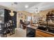 Modern kitchen with black appliances open to living area and dining space with stylish decor at 9060 Watermelon Seed Ave, Las Vegas, NV 89143