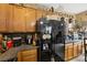 Modern kitchen with stainless steel refrigerator and dark countertops and cabinets at 9060 Watermelon Seed Ave, Las Vegas, NV 89143