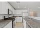 Modern kitchen with granite countertops, stainless steel appliances, and white cabinetry at 9543 Havasu Canyon Ave, Las Vegas, NV 89166