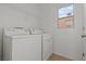 Bright laundry room features standard sized white washer and dryer and wire shelf at 9543 Havasu Canyon Ave, Las Vegas, NV 89166