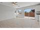 Bright living room featuring tile flooring and sliding glass doors leading to the backyard at 9543 Havasu Canyon Ave, Las Vegas, NV 89166