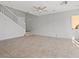 Spacious living room featuring tile flooring, a ceiling fan, and staircase access to the second floor at 9543 Havasu Canyon Ave, Las Vegas, NV 89166