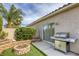 This cozy backyard features artificial grass, a built-in BBQ, and a charming brick fire pit at 9664 Emeraude Ave, Las Vegas, NV 89147