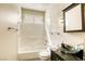Bright bathroom featuring a sleek vanity with glass bowl sink and modern fixtures at 9664 Emeraude Ave, Las Vegas, NV 89147