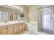 Bathroom features double sinks, large mirror, shower, and bathtub at 9664 Emeraude Ave, Las Vegas, NV 89147