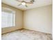 Neutral bedroom featuring tile floors, ceiling fan, and a large window at 9664 Emeraude Ave, Las Vegas, NV 89147