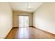 Bright bedroom with a ceiling fan and wood floors and sliding glass door at 9664 Emeraude Ave, Las Vegas, NV 89147