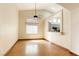 Open dining room features wood flooring, a view to the kitchen and fan at 9664 Emeraude Ave, Las Vegas, NV 89147