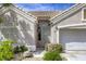 Inviting front entrance with a secure screen door and charming landscaping at 9664 Emeraude Ave, Las Vegas, NV 89147