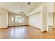 Bright living room with vaulted ceilings, modern fan, and light wood flooring at 9664 Emeraude Ave, Las Vegas, NV 89147