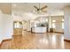 Spacious living room with light wood floors, kitchen access, and vaulted ceiling at 9664 Emeraude Ave, Las Vegas, NV 89147