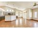 Open floor plan with light wood floors, vaulted ceilings, and kitchen view at 9664 Emeraude Ave, Las Vegas, NV 89147