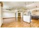 Spacious, open-concept living room with light wood floors and easy kitchen access at 9664 Emeraude Ave, Las Vegas, NV 89147