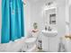 Bright half bathroom with turquoise curtain, a charming sink and decorative plant in a well-lit space at 9958 Fragile Fields St, Las Vegas, NV 89183