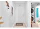 Bright entryway features white walls, decorative accents, and a view into the laundry area with stacked washer and dryer at 9958 Fragile Fields St, Las Vegas, NV 89183