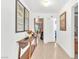 Neutral hallway with tiled floor leads to various rooms and displays decorative accents on the console table at 9958 Fragile Fields St, Las Vegas, NV 89183