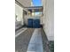 Narrow side yard featuring gravel, concrete walkway, and a covered walkway at 9958 Fragile Fields St, Las Vegas, NV 89183